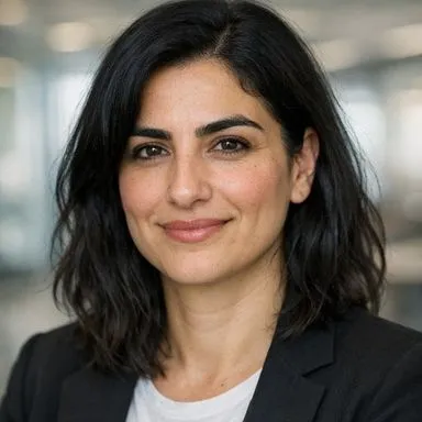 Late-30s man with black hair and thick brows, olive skin, calm expression, dark blazer